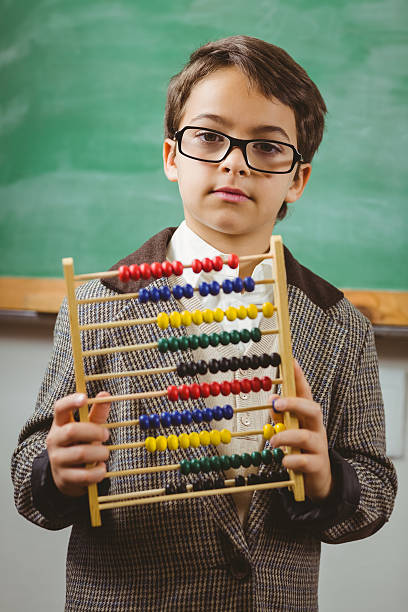 istock Pupil dressed up as teacher holding abacus 486059780