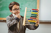 Pupil dressed up as teacher holding abacus
