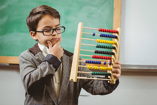 Pupil dressed up as teacher holding abacus stock photo