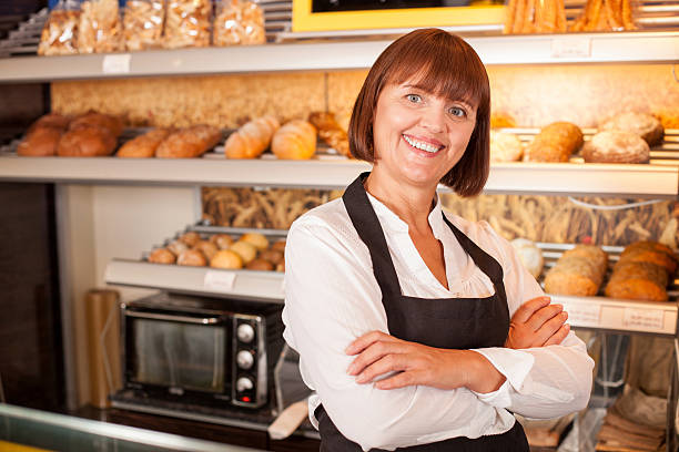 istock Cheerful female baker is presenting her pastry 486066550