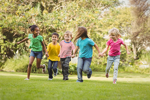 istock Happy classmates running and holding hands 486066594