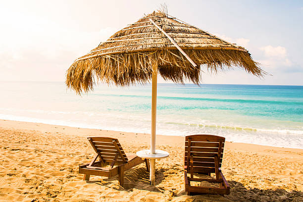 istock Beach chairs and umbrella on a beautiful panoramic beach view 486066678