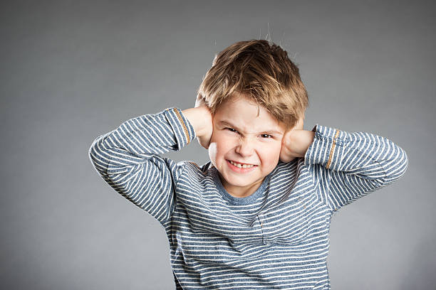 istock Portrait of boy, hear no evil, grey background 486067280