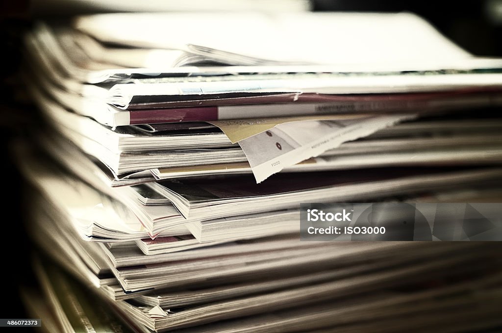 Pile of magazines Pile of magazines. Edited with grain and filters Magazine - Publication Stock Photo