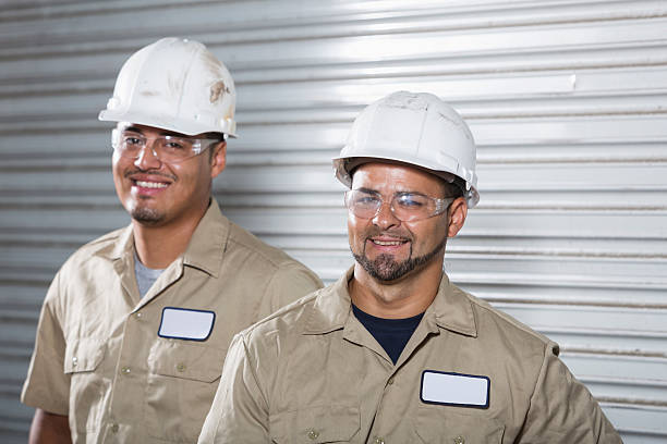 istock Hispanic workers wearing hardhat and safety glasses 486073689
