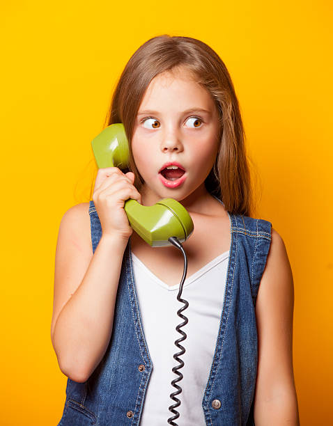 istock Young surprised girl with green handset 486074100