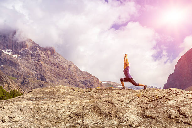istock Young woman doing yoga exercise with sun 486074396