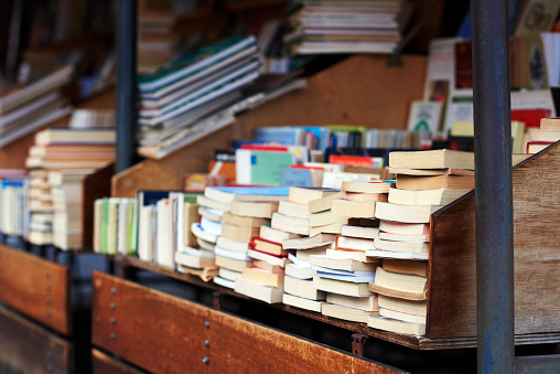 stand with stacks of books, outdoor shoot.