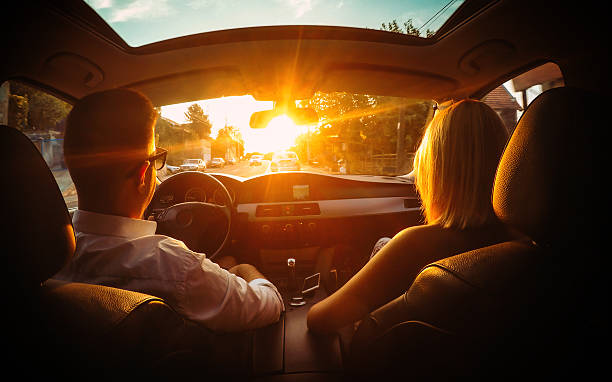 In  car Young couple in a car on the road. over the shoulder view photos stock pictures, royalty-free photos & images