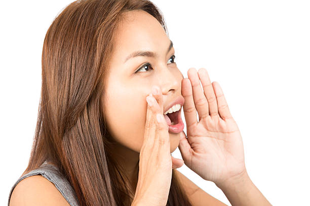 istock Asian Girl Telling Secret Hands Protecting Mouth 486079104