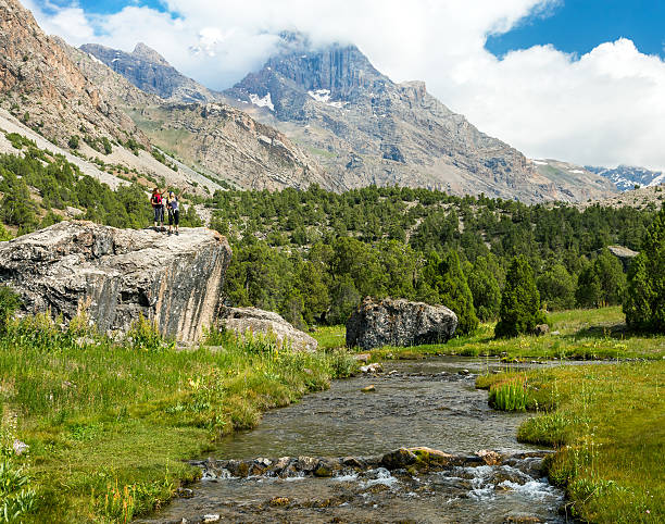 istock Mountain Stream and Female Hikers on Rock 486079206