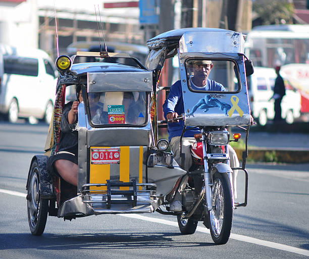 Tricycle on the street, Boracay, Philippines Boracay, Philippines - January 29, 2011: Tricycle motor running on the street in Boracay, Philippines. Motorized tricycles are a common means of passenger transport everywhere in the Philippines. philippines tricycle stock pictures, royalty-free photos & images