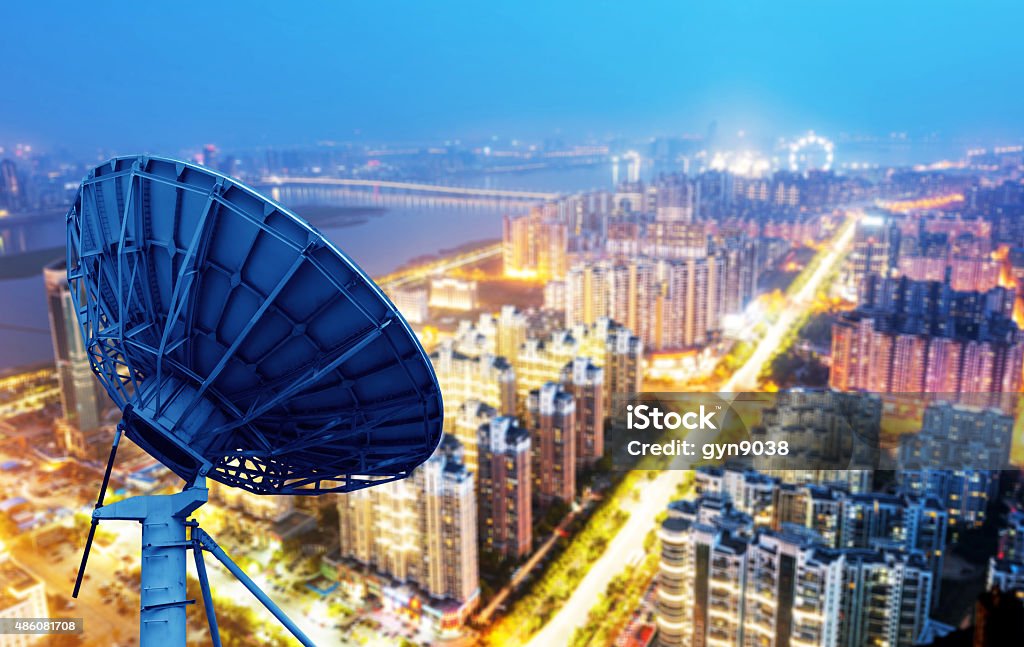 Dish and city views picture of parabolic satellite dish space technology receivers Broadcasting Stock Photo