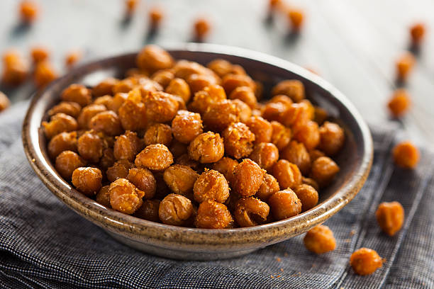 Healthy Roasted Seasoned Chick Peas Healthy Roasted Seasoned Chick Peas with Varies Spices crunchy photos stock pictures, royalty-free photos & images