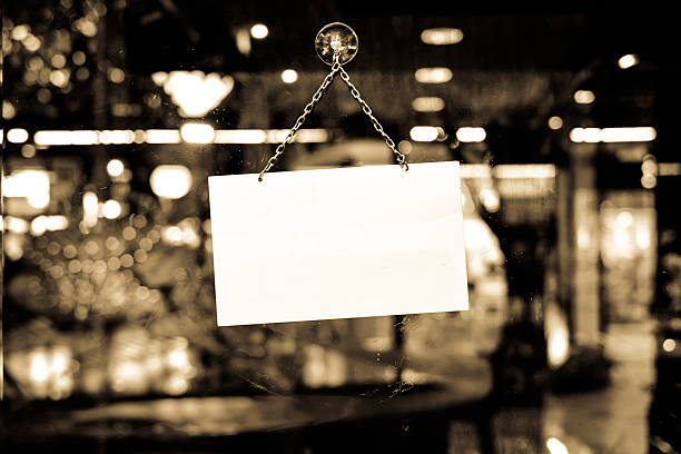 Sign with space for text hanging in a shop window