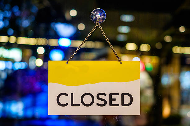 istock Closed sign hanging in a shop window 486090468