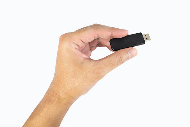 istock hand holding flash drive isolated on white background 486090602