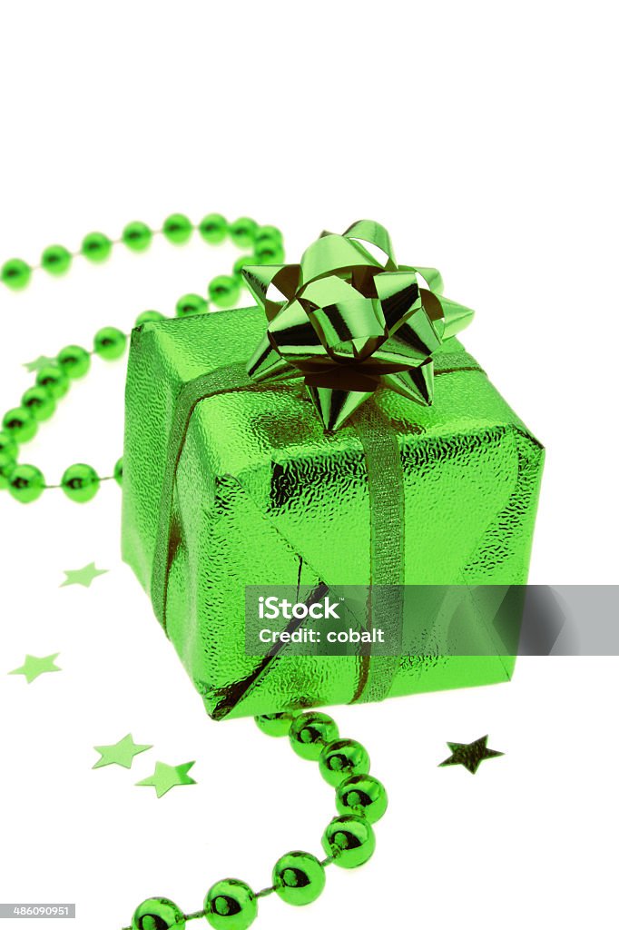 Shiny green gift and stars on white Christmas Stock Photo