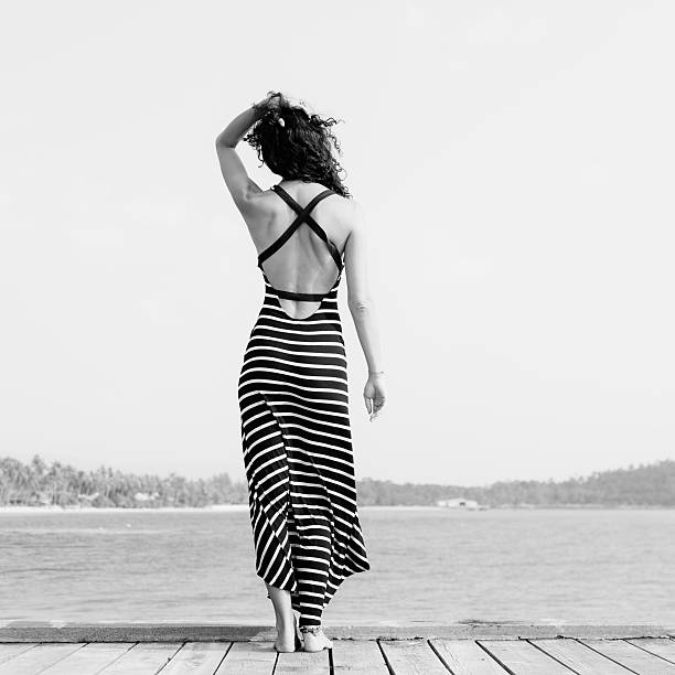 istock Young pretty woman standing alone on the pier 486090996