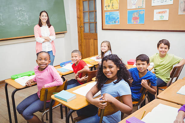 istock Students and teacher looking at the camera 486091198