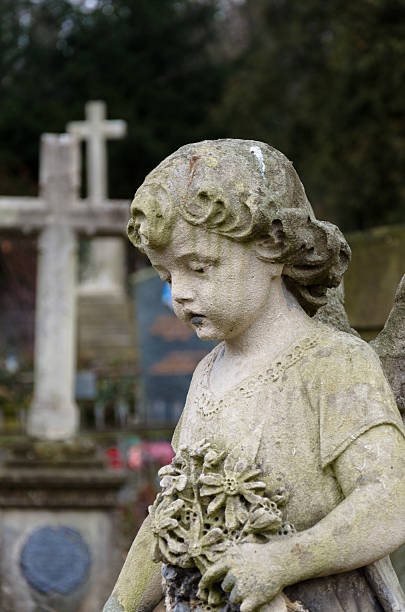 istock statue of baby angel on the graveyard 486091633