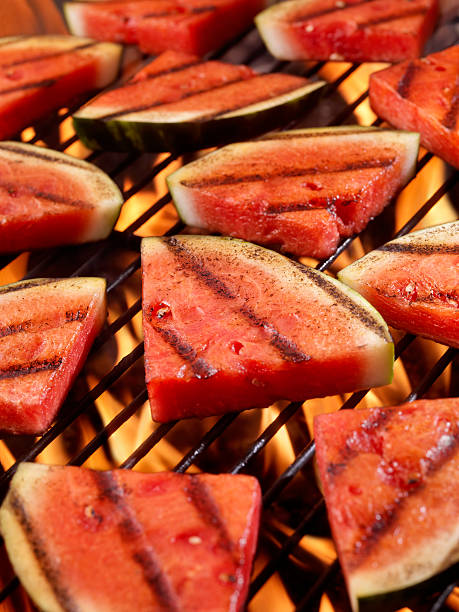 BBQ Watermelon BBQ Watermelon on a Outdoor BBQ -Photographed on Hasselblad H3D2-39mb Camera char grilled photos stock pictures, royalty-free photos & images