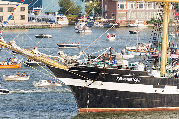 Tall ship Kruzenshtern leaving Amsterdam SAIL 2015 Amsterdam, the Netherlands - August 23, 2015: Tall ship Kruzenshtern leaving Amsterdam after the SAIL 2015 event. Kruzenshtern is a four masted tall ship built in 1926 in Germany. Today it sails under the Russian flag. SAIL is the biggest public event in the Netherlands. Famous tall ships visit the city. Small boats are allowed to enter the harbour.  krusenstern stock pictures, royalty-free photos & images
