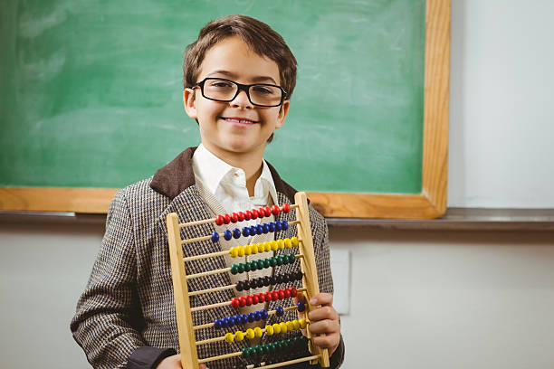 istock Smiling pupil dressed up as teacher holding abacus 486094460