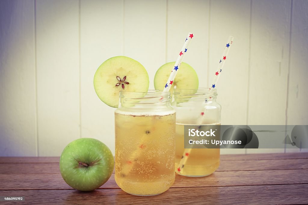 Apple Cider Apple Cider in glass jars on a wooden surface Somerset - England Stock Photo