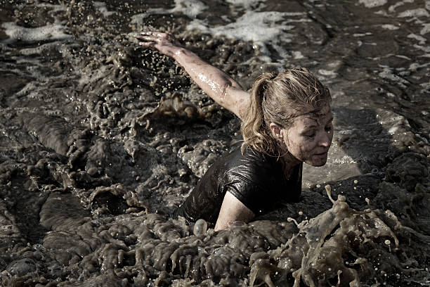 istock woman swimming in dirty water 486095332