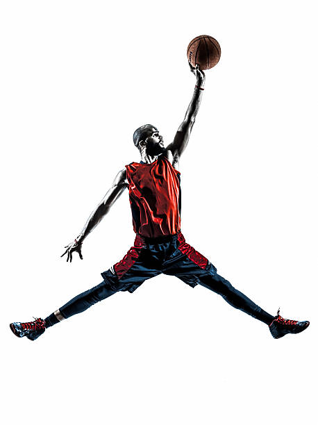 istock african man basketball player jumping dunking silhouette 486099511