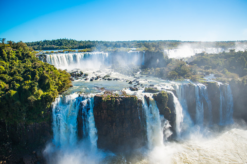 Iguazu Falls is located where the Iguazu River tumbles over the edge of the Paraná Plateau, 23 kilometres (14 mi) upriver from the Iguazu's confluence with the Paraná River.