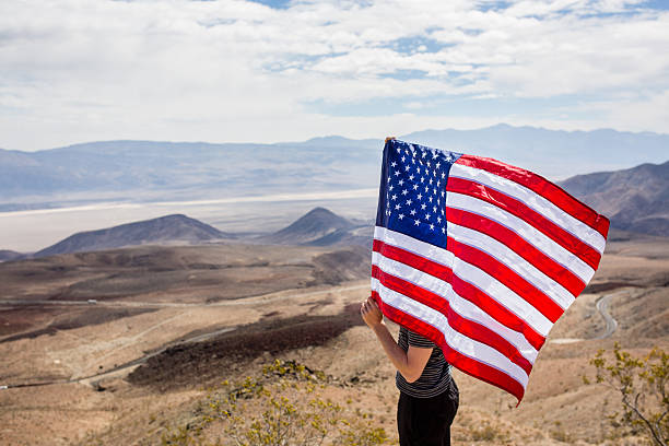 istock Man with US flag in Death Valley 486100508