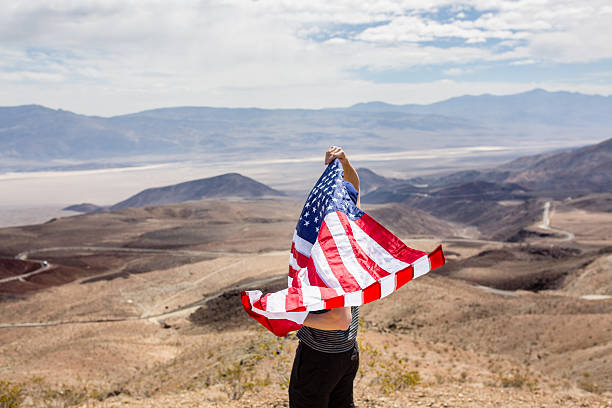 istock Man with US flag in Death Valley 486100522