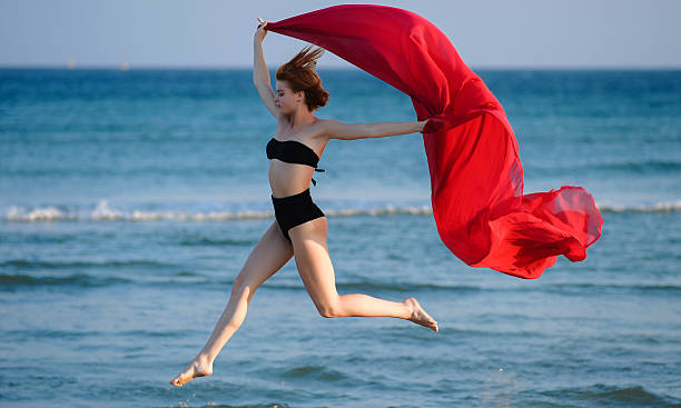istock Beautiful woman in bikini in summer jumping on 486100582