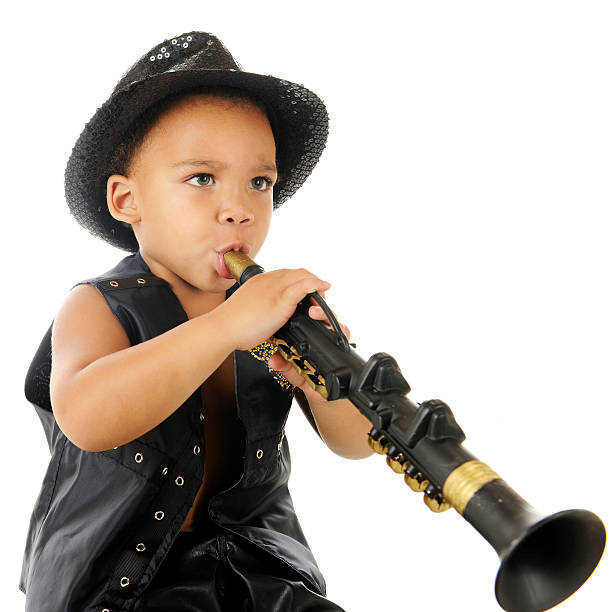 Preschool Rocker An adorable preschooler playing a toy clarinet (upside down) in his sparkly fedora and balck leather vest. On a white background. black hat upside down stock pictures, royalty-free photos & images