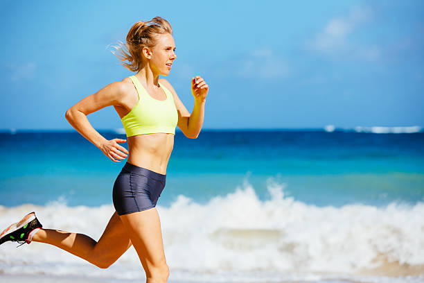 istock Athletic Young Woman Running on the Beach 486110343