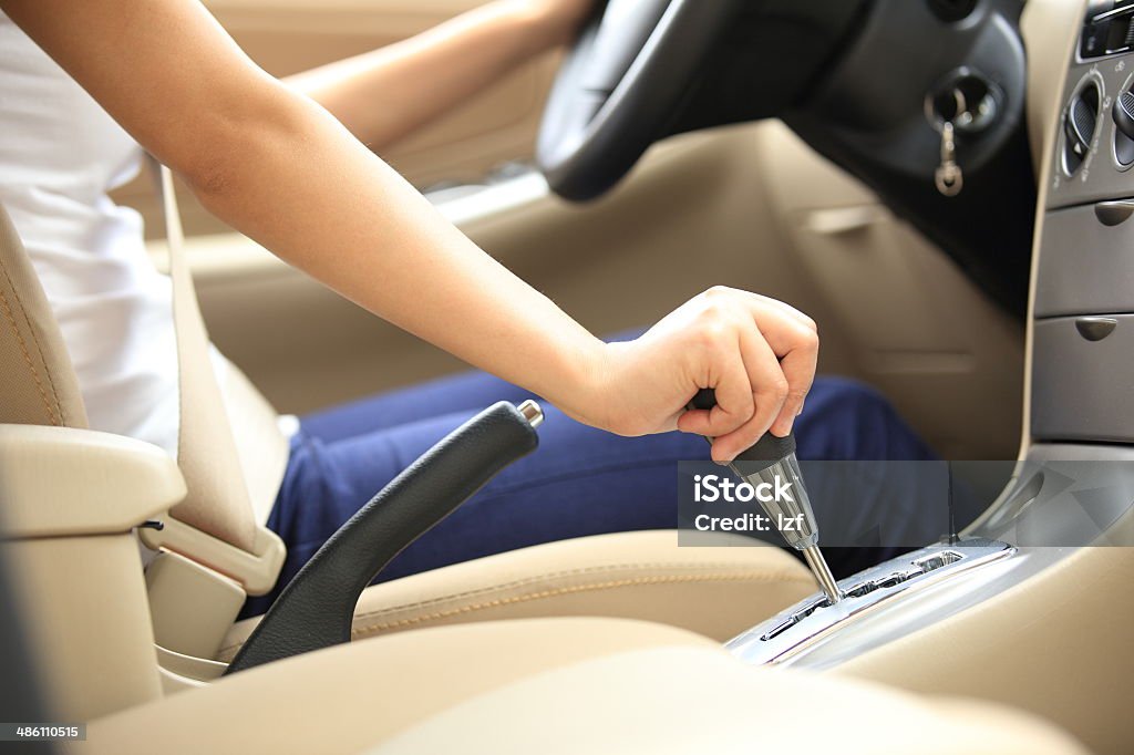 woman driver shifting the gear stick woman driver driving a car and shifting the gear stick Change Stock Photo