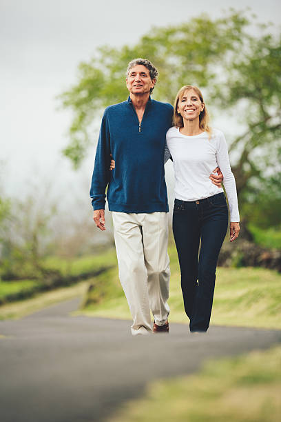 istock Happy loving middle aged couple walking 486110661