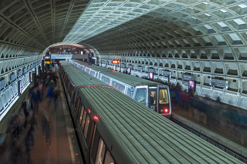 Two trains stop for passengers at metro stop in interesting architecturally designed underground tunnel at Union Station in Washington D.C. 