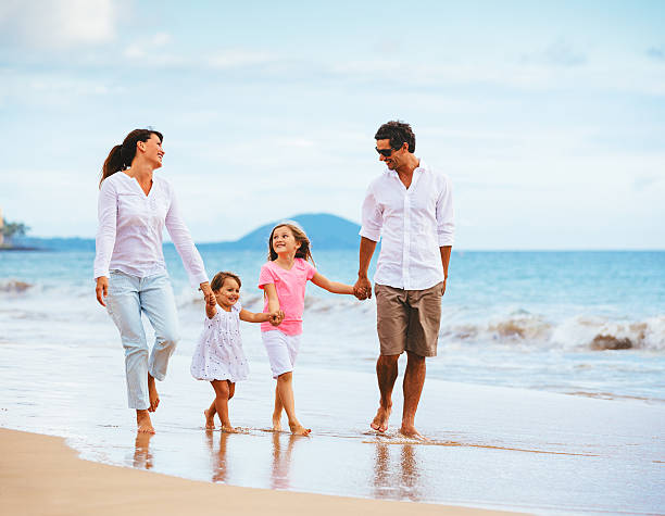 istock Happy young family walking on the beach 486111719