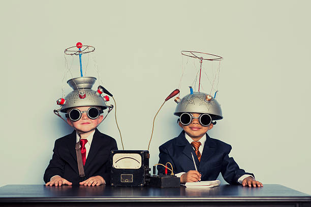 Two Business Boys with Mind Reading Helmets Two young boys are ready to dive into the brain of your business. Analyze that. uncool stock pictures, royalty-free photos & images