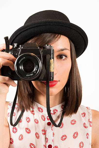 istock Young woman with retro photocamera 486120024