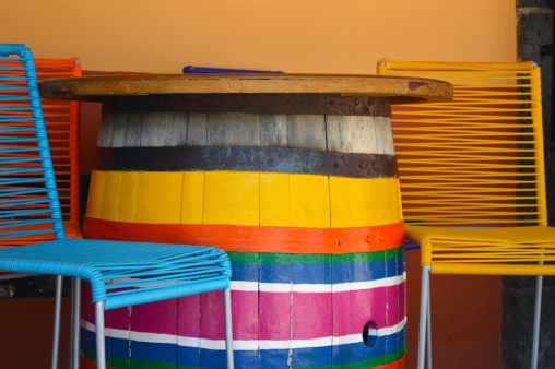 Colorful chairs and barrel table on mexican plaza