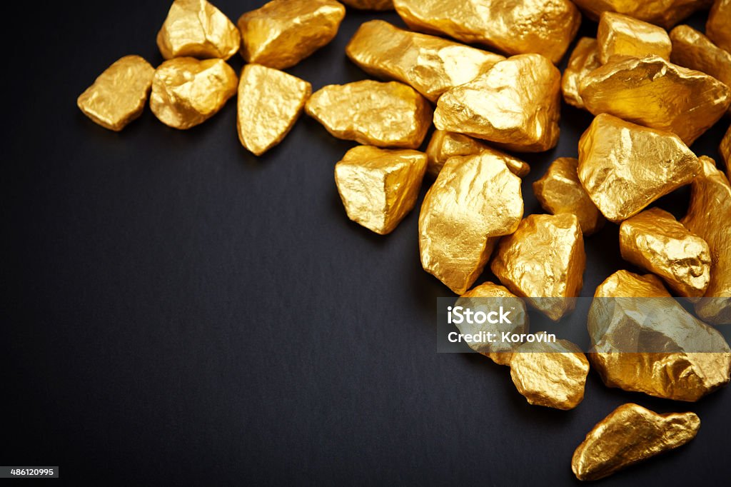 gold nuggets on a black background. closeup. Ingot Stock Photo