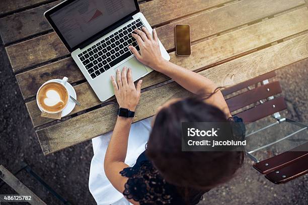 Woman Working On Her Laptop At Cafe Stock Photo - Download Image Now - Laptop, Outdoors, Coffee - Drink