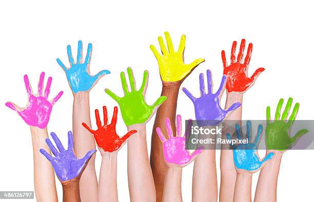 Multiethnic Arms Raised And Colorful Painted Hands Stock Photo - Download Image Now