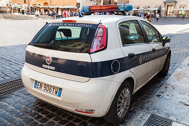 White Fiat Punto police car stands parked Rome, Italy - August 8, 2015: White Fiat Fiat Grande Punto police car stands parked on the city roadside punto stock pictures, royalty-free photos & images