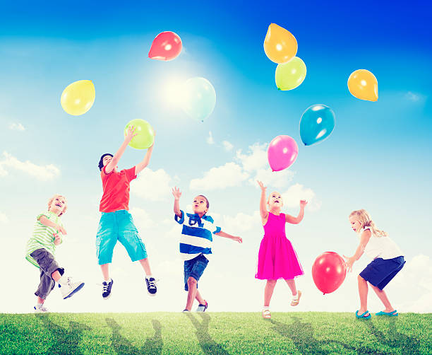 istock Multi-Ethnic Children Outdoors Playing Balloons Together 486133495