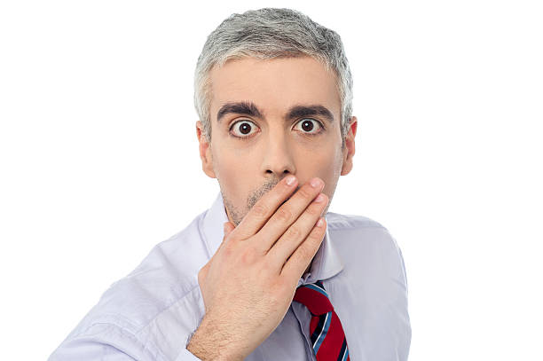 istock Young businessman closing mouth with hand 486133633